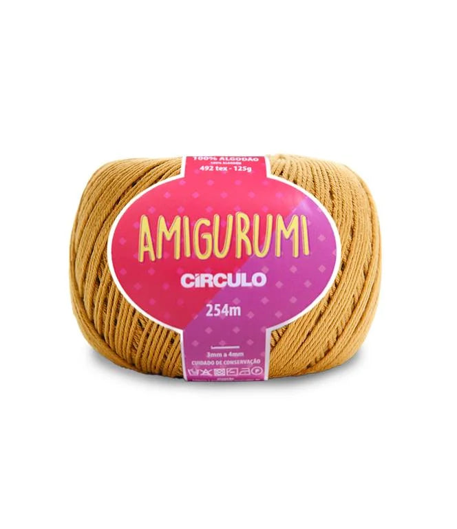 A skein of Circulo brand mustard yellow amigurumi cotton yarn with label showing the brand name and yardage.
