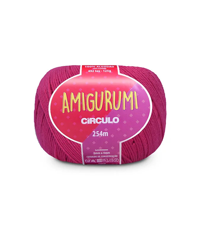 A skein of Circulo brand rose pink amigurumi cotton yarn with label showing the brand name and yardage.