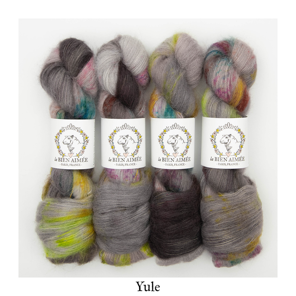 An image of four skeins of La Bien Aimee lace weight yarn in the Yule colorway with white ‘La Bien Aimee’ labels against a white background.
