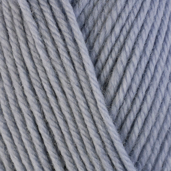 A close-up image of a skein of Berroco Ultra Wool bulky weight yarn in a pale purple gray color.