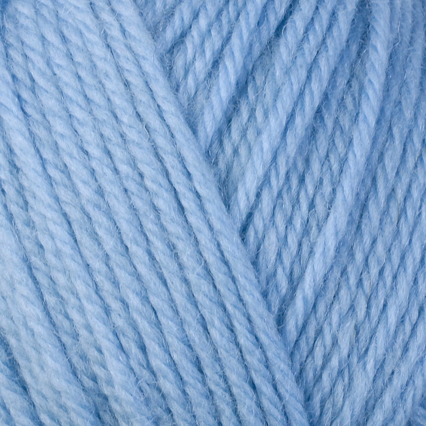 A close-up image of a skein of Berroco Ultra Wool bulky weight yarn in a light blue color.