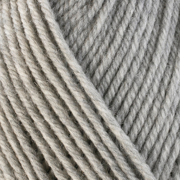 A close-up image of a skein of Berroco Ultra Wool bulky weight yarn in a heathered pale gray color.