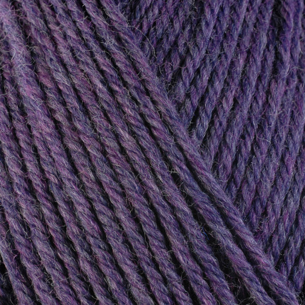 A close-up image of a skein of Berroco Ultra Wool bulky weight yarn in a heathered purple color.