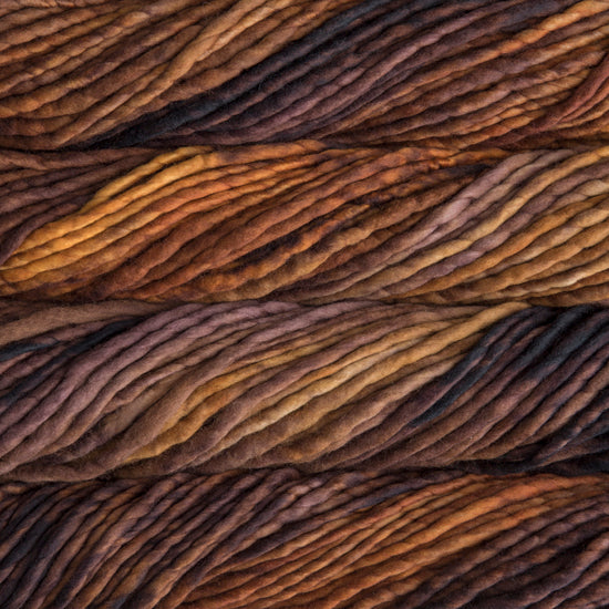 A close-up image of skeins of Malabrigo Rasta yarn in varying shades of light and dark brown, displaying the texture and color variation.