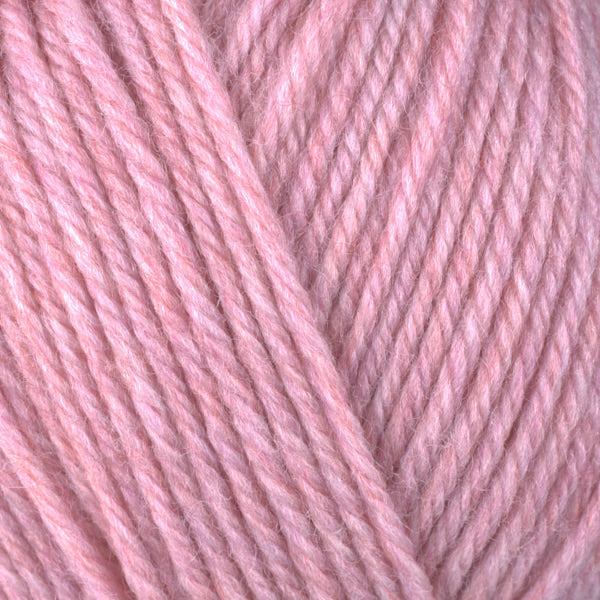 A close-up image of a skein of Berroco Ultra Wool worsted weight yarn in a heathered soft pink color.