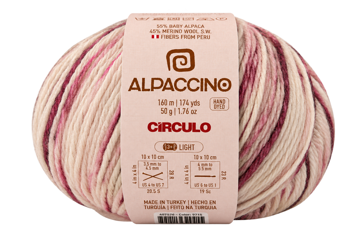 A ball of Alpaccino yarn by Circulo, featuring variegated light pink, cream, and mauve stripes with a beige paper label.