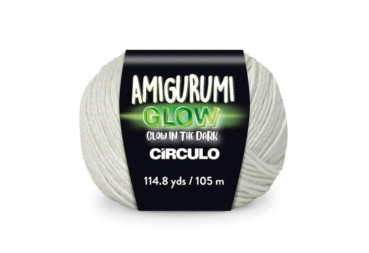 An image of a ball of Circulo Amigurumi glow in the dark fingering weight yarn in the color white with a black, white, and green ‘Amigurumi Glow’ label against a white background.