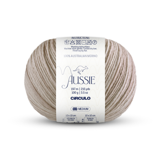 Ball of light beighe yarn with a 'Aussie' label on a white background