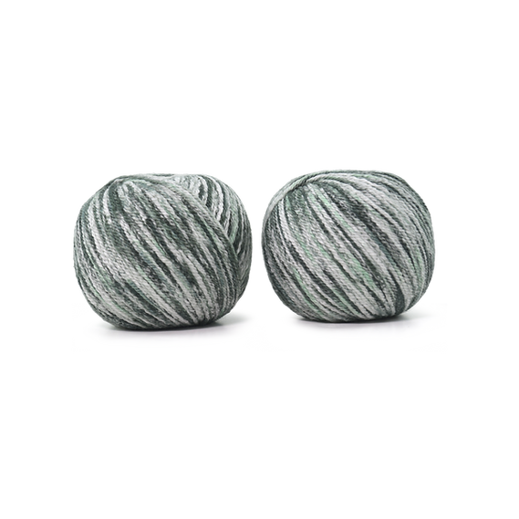 An image of two balls of Circulo Let it Sock sport weight yarn in the colors green and white against a white background.