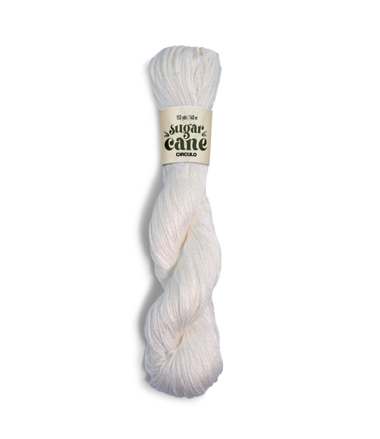 An image of a skein of Circulo DK weight yarn in a solid white color with a ‘Sugar Cane’ label against a white background.