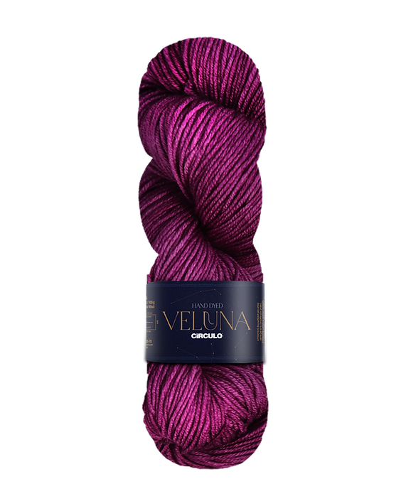 Skein of burgundy yarn with a label on a white background