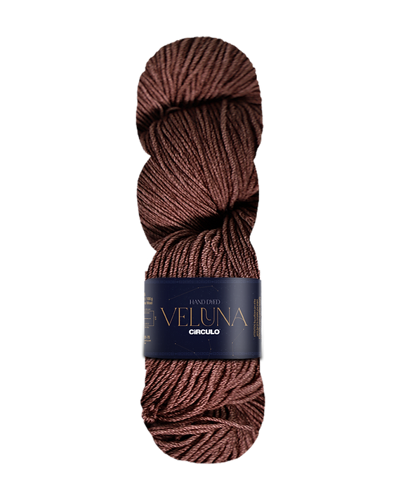 Brown skein of yarn with a label on a white background