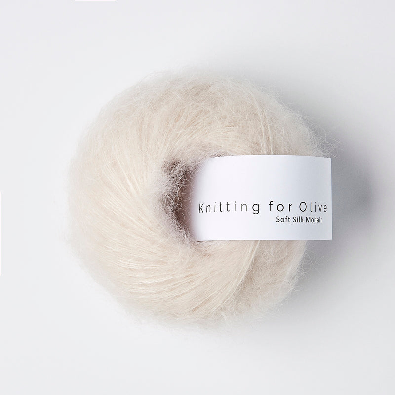 Ball of fluffy cream yarn with 'Knitting for Olive' label on a white background