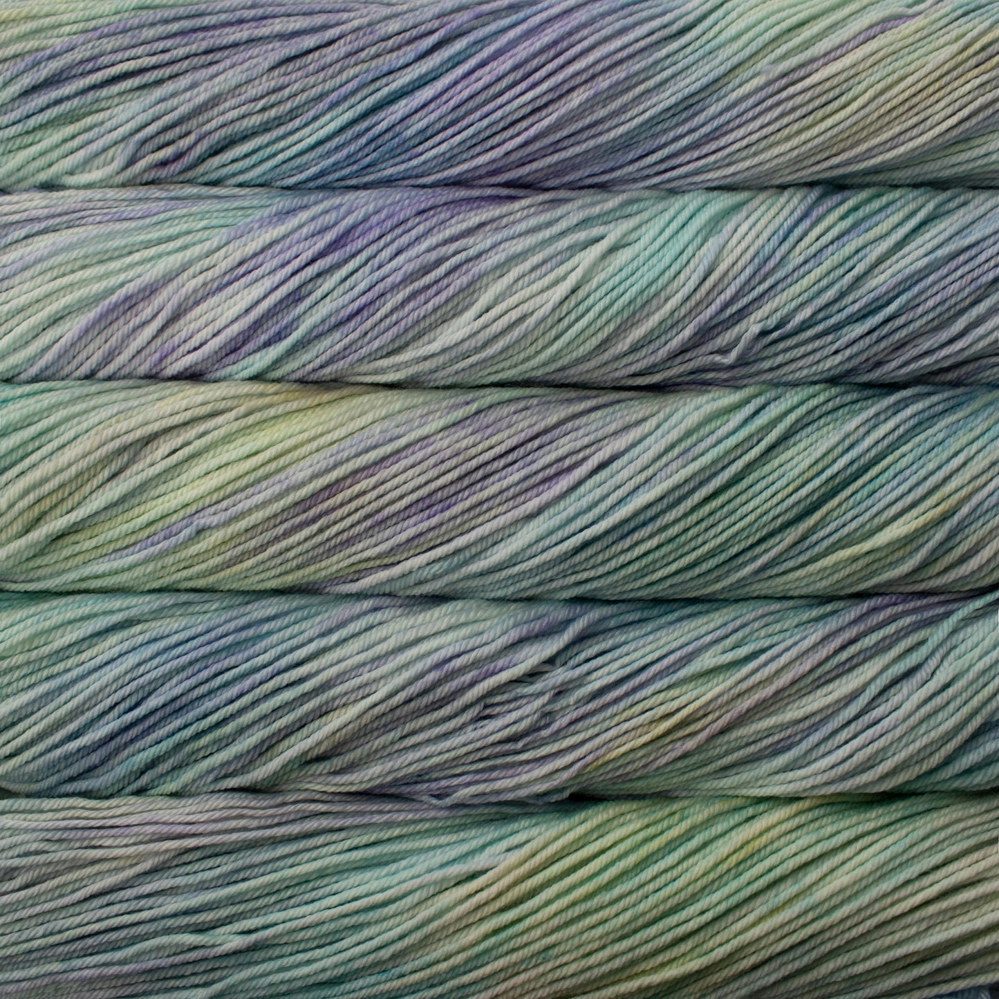 A close up of skeins of Malabrigo Rios worsted weight yarn in green, blue, purple colors