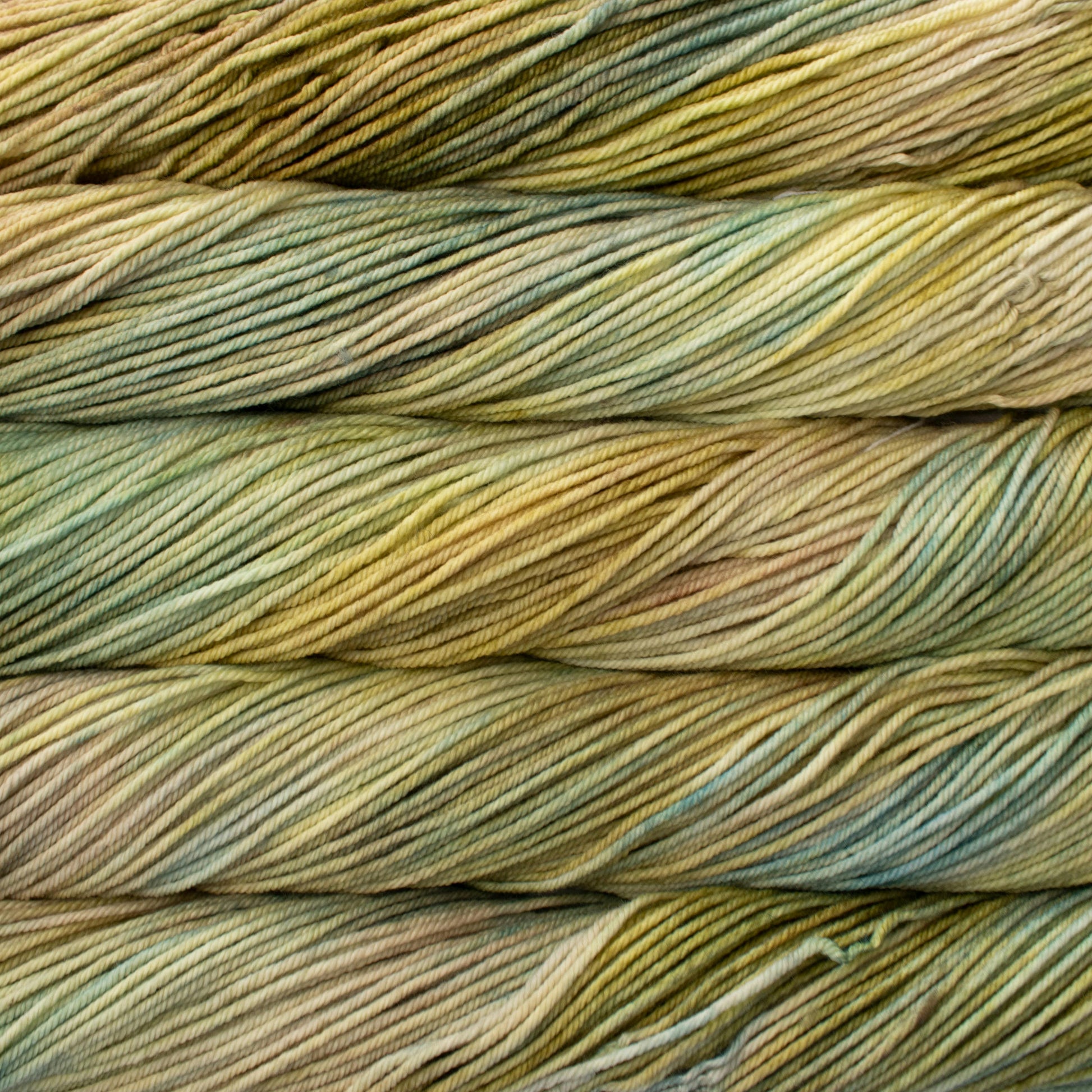 A close up of skeins of Malabrigo Rios worsted weight yarn in yellow and light green colors.
