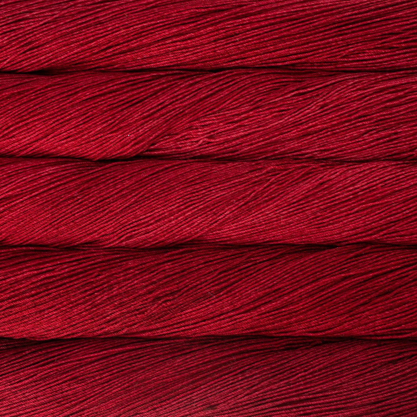 Close-up of red Malabrigo Ultimate sock yarn.