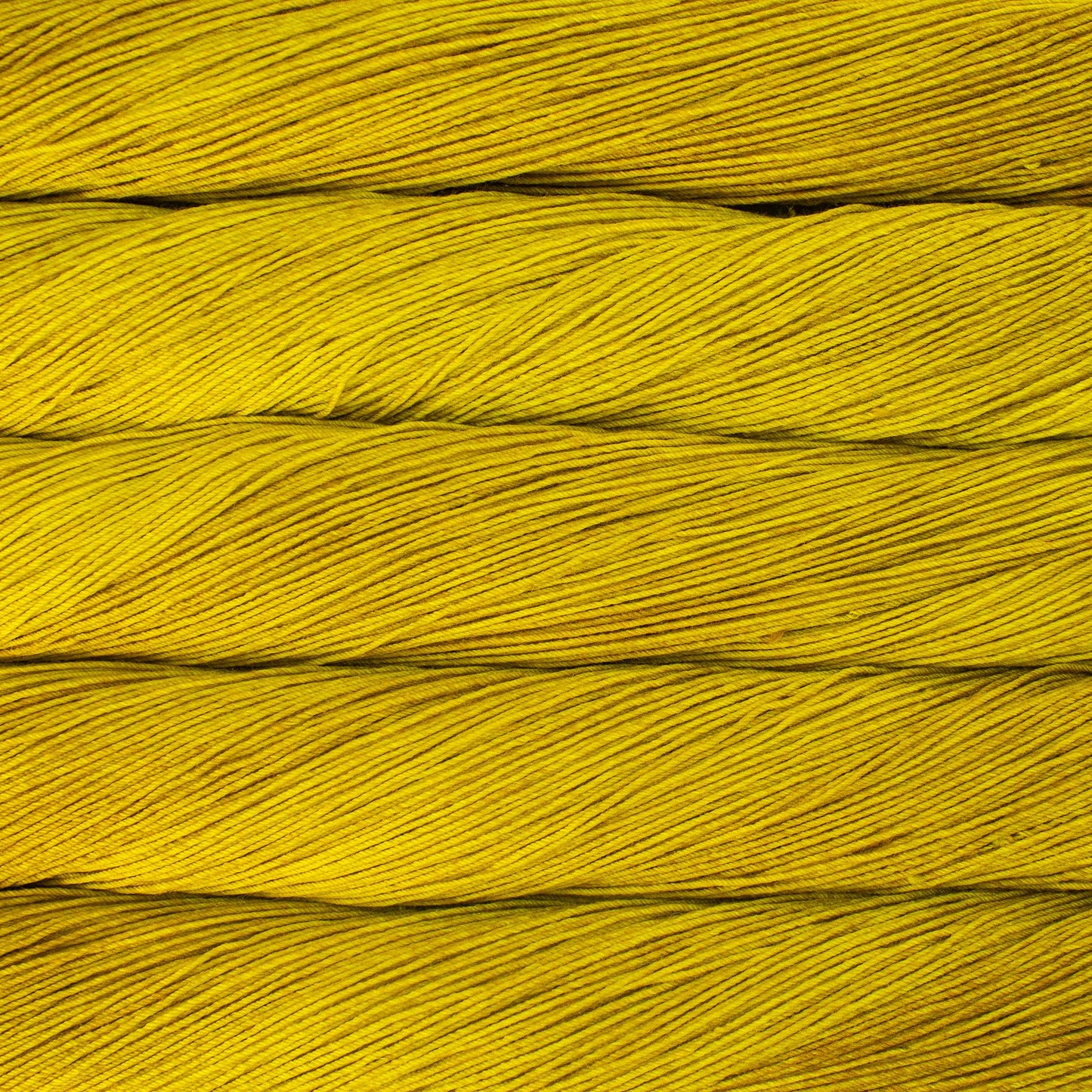 Close up of several skeins of bright golden yellow yarn