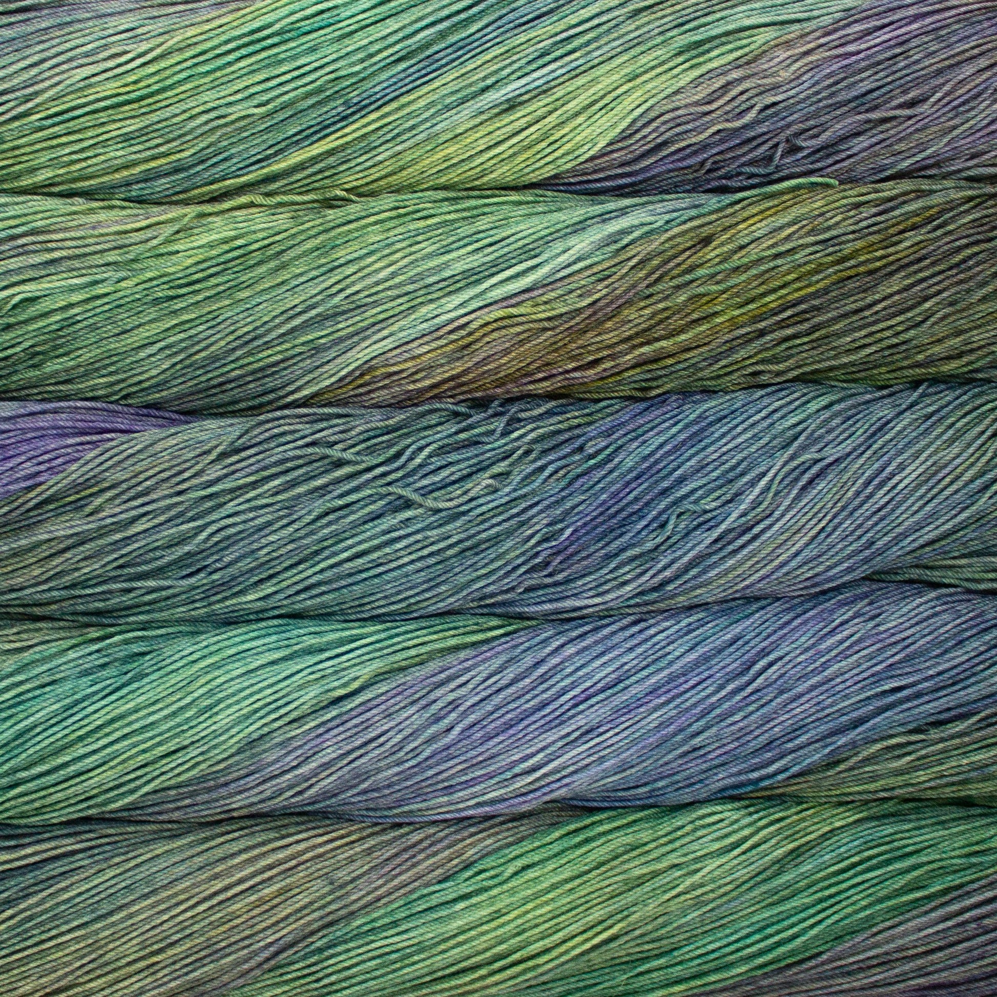 Close-up of multicolored yarn with shades of green, blue, and purple.