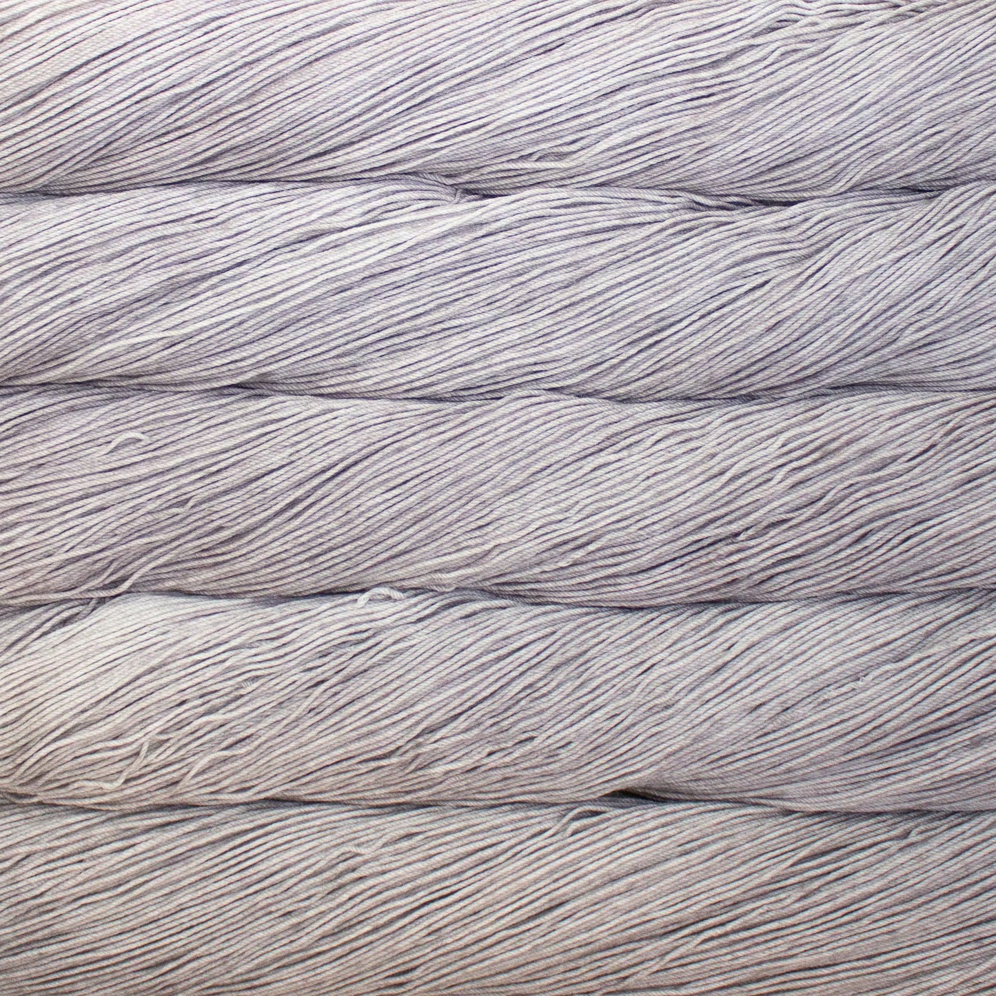 A close up of a skein of Malabrigo Ultimate Sock fingering weight yarn in light grey color