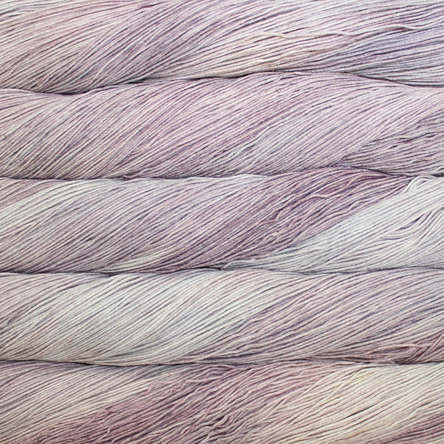 Close up of multiple skeins of light pink yarn