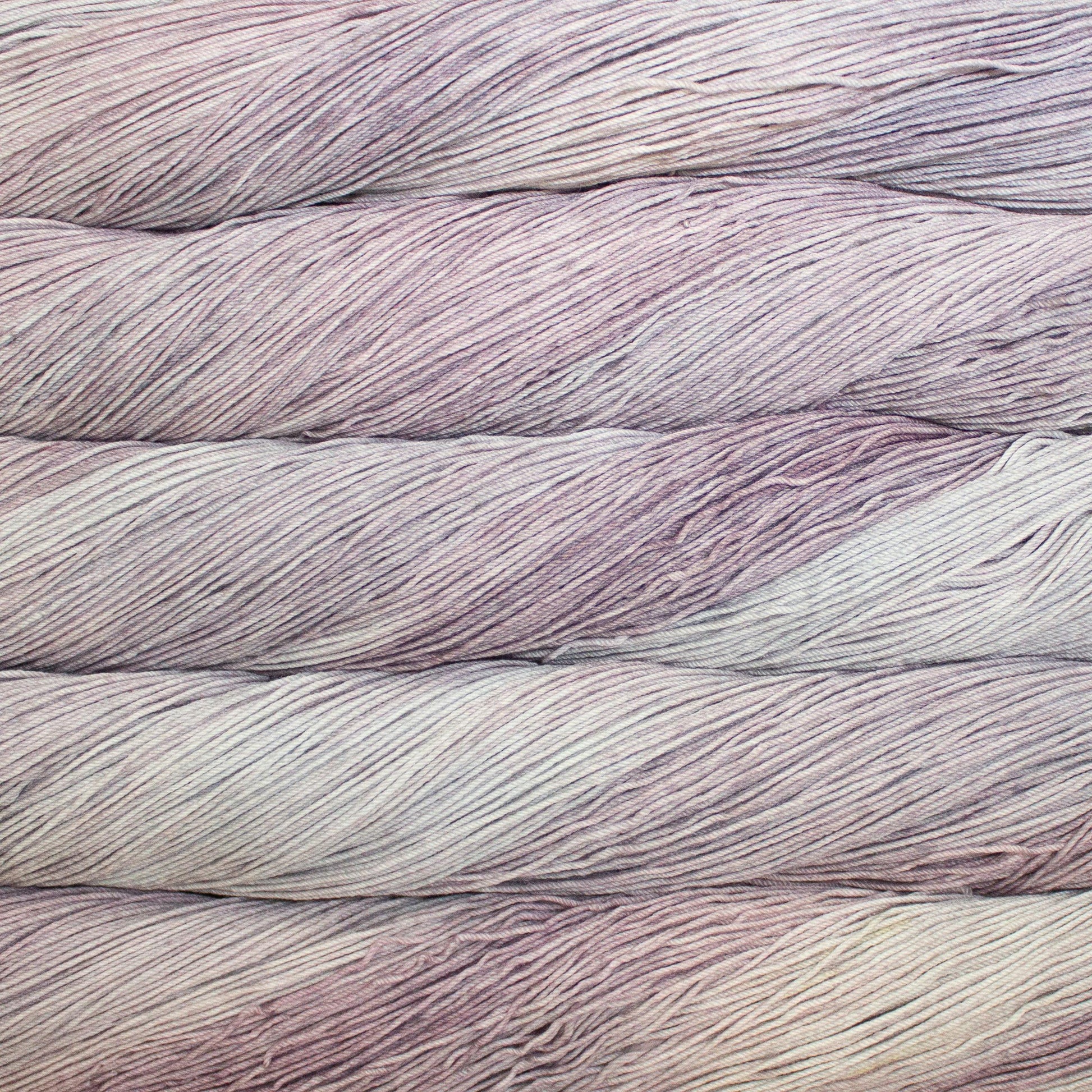 Close up of multiple skeins of light pink yarn