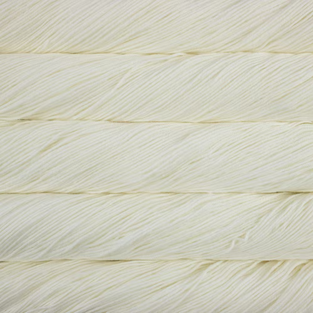 A close up of a skein of Malabrigo Ultimate Sock fingering weight yarn in off white color