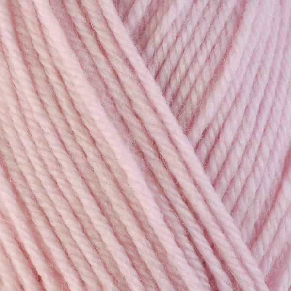 A close-up image of a skein of Berroco Ultra Wool worsted weight yarn in a solid pale pink color.