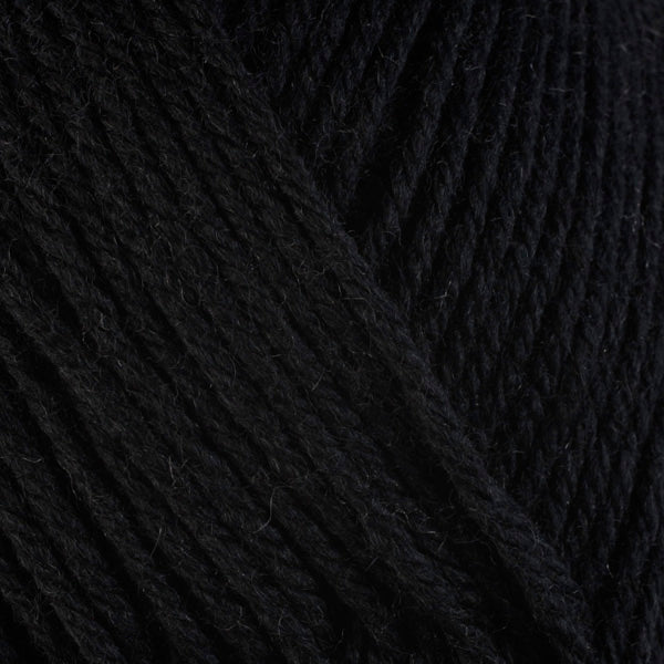 A close-up image of a skein of Berroco Ultra Wool worsted weight yarn in a solid black color.
