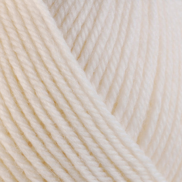 A close-up image of a skein of Berroco Ultra Wool worsted weight yarn in a solid cream color.