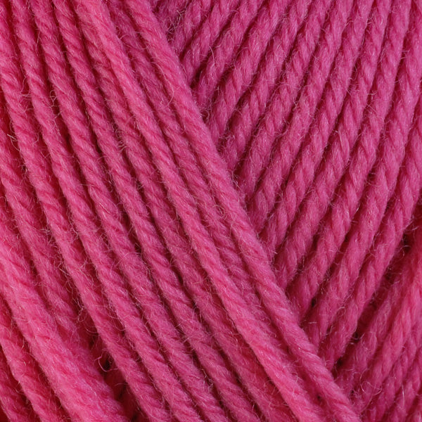 A close-up image of a skein of Berroco Ultra Wool worsted weight yarn in a solid hot pink color.