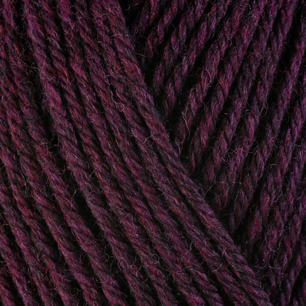 A close-up image of a skein of Berroco Ultra Wool worsted weight yarn in a heathered berry color.