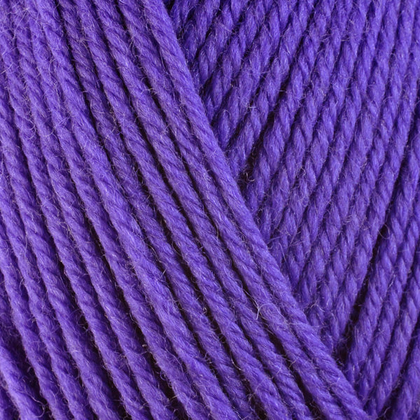 A close-up image of a skein of Berroco Ultra Wool worsted weight yarn in a solid bright purple color.