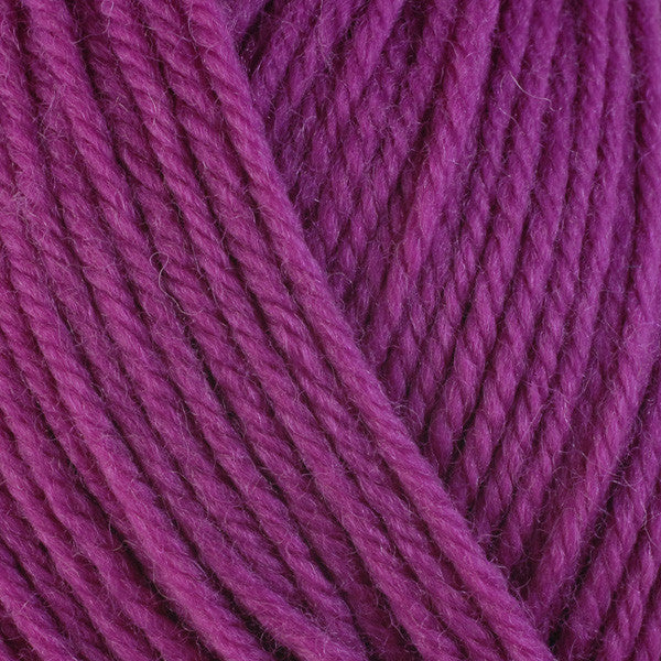 A close-up image of a skein of Berroco Ultra Wool worsted weight yarn in a solid magenta color.