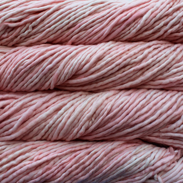 A close-up image of skeins of Malabrigo Rasta yarn in pale pink, displaying the texture and color variation.