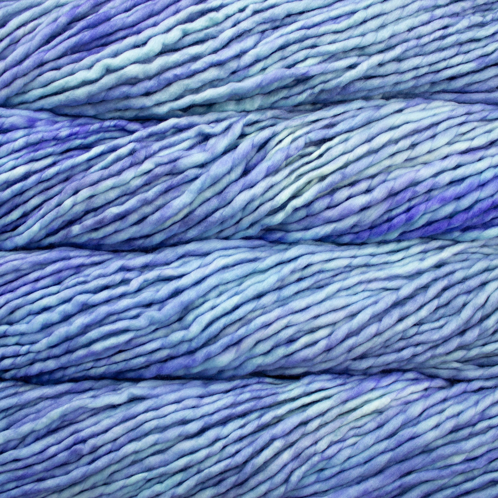 A close-up image of skeins of Malabrigo Rasta yarn in pale blue and purple, displaying the texture and color variation.