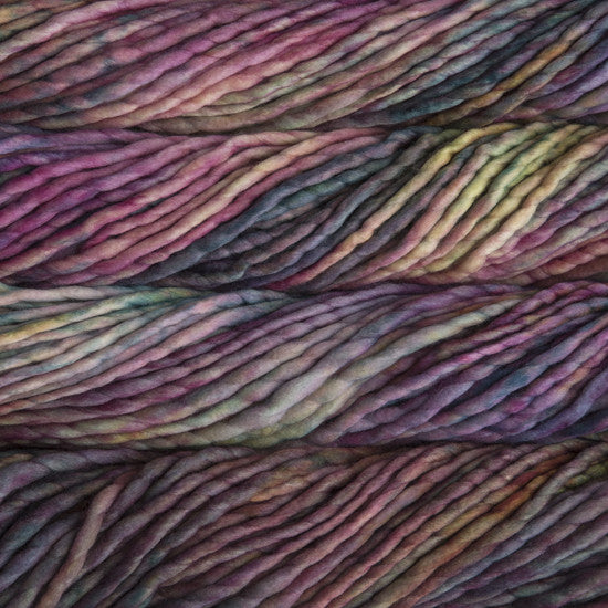 A close-up image of skeins of Malabrigo Rasta yarn in shades of purple and green, displaying the texture and color variation.
