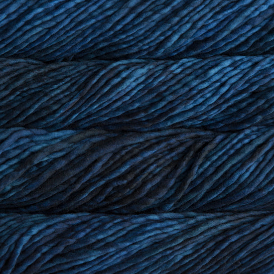A close-up image of skeins of Malabrigo Rasta yarn in deep blue shades, displaying the texture and color variation.