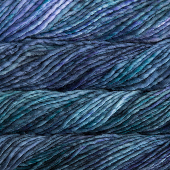 A close-up image of skeins of Malabrigo Rasta yarn in blue, teal, and purple shades, displaying the texture and color variation.