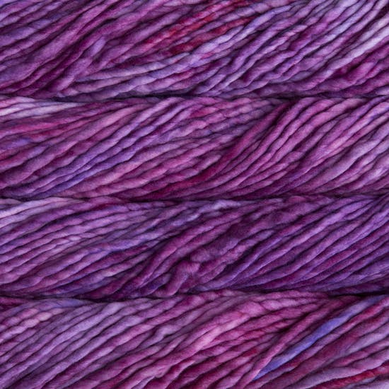 A close-up image of skeins of Malabrigo Rasta yarn in purple and magenta shades, displaying the texture and color variation.