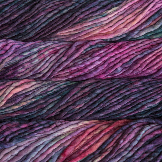 A close-up image of skeins of Malabrigo Rasta yarn in shades of pink, purple, and blue, displaying the texture and color variation.
