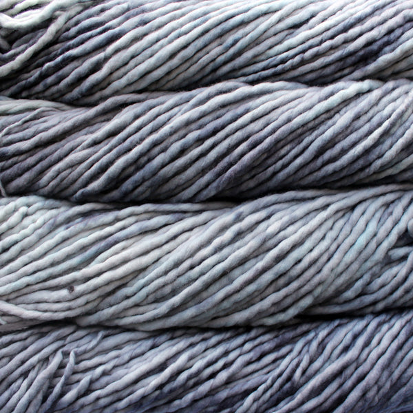 A close-up image of skeins of Malabrigo Rasta yarn in pale gray, displaying the texture and color variation.