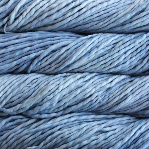 A close-up image of skeins of Malabrigo Rasta yarn in pale blue shades, displaying the texture and color variation.