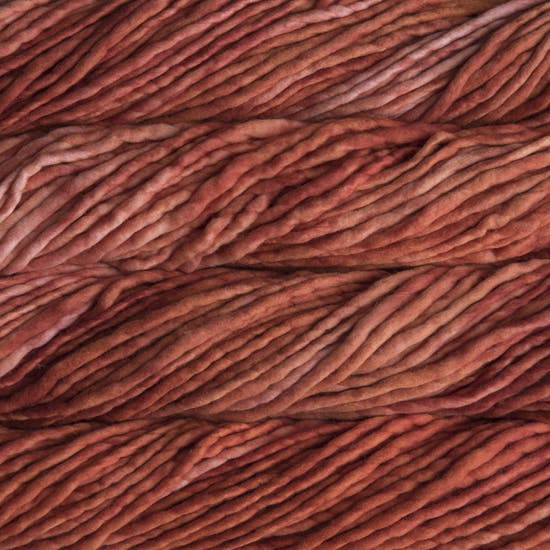 A close-up image of skeins of Malabrigo Rasta yarn in rust orange, displaying the texture and color variation.
