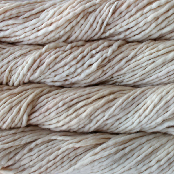A close-up image of skeins of Malabrigo Rasta yarn in a cream color, displaying the texture and color variation.