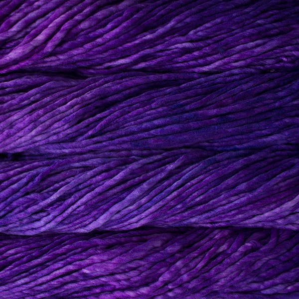 A close-up image of skeins of Malabrigo Rasta yarn in deep purple shades, displaying the texture and color variation.