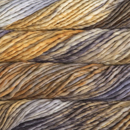 A close-up image of skeins of Malabrigo Rasta yarn in shades of yellow and brown, displaying the texture and color variation.