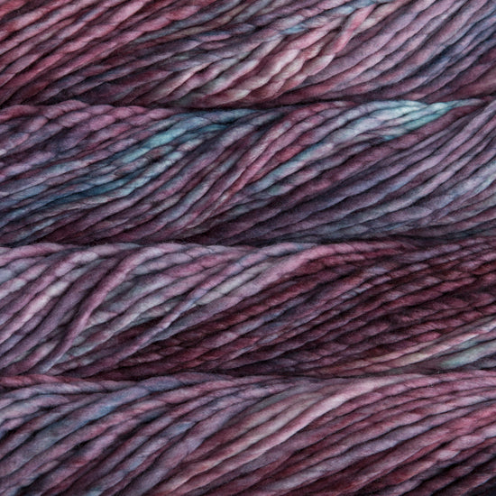 A close-up image of skeins of Malabrigo Rasta yarn in shades of purple and light blue, displaying the texture and color variation.