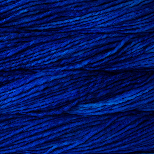 A close-up image of skeins of Malabrigo Rasta yarn in deep blue shades, displaying the texture and color variation.