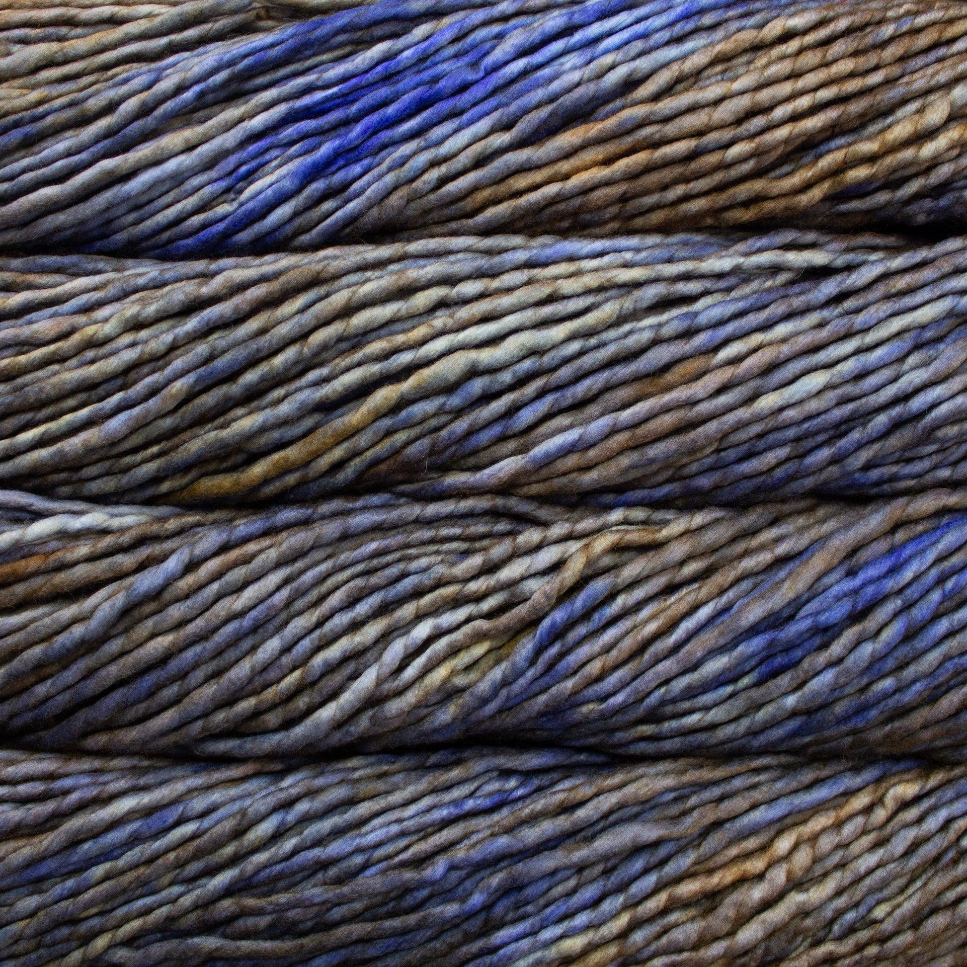 A close-up image of skeins of Malabrigo Rasta yarn in shades of blue and yellow brown, displaying the texture and color variation.