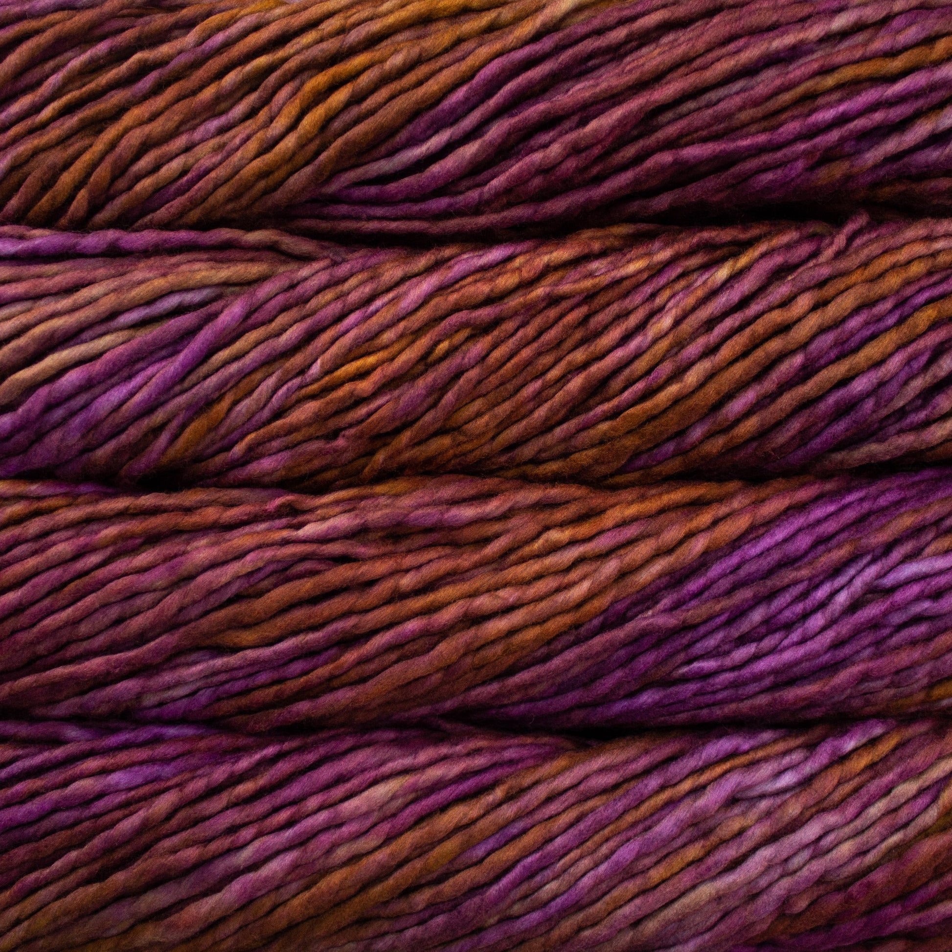 A close-up image of skeins of Malabrigo Rasta yarn in shades of purple and orange, displaying the texture and color variation.